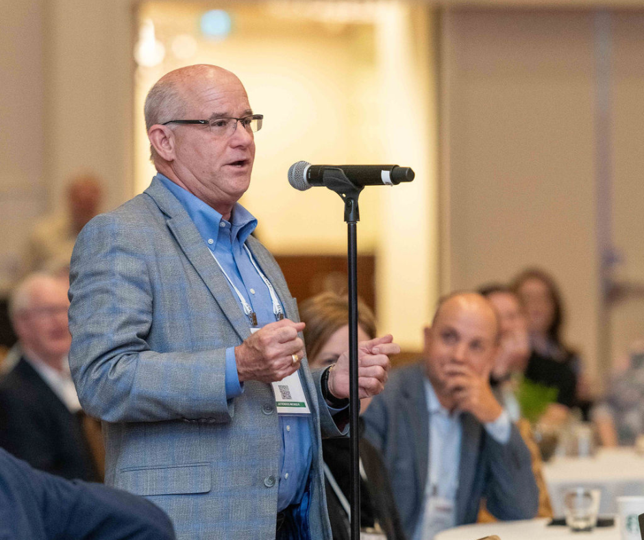 Attendee speaking at microphone