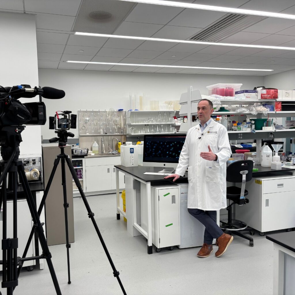 Dr. Aaron Goodarzi speaking to media in the Transdisciplinary Cancer Research Hub (Photo Credit: Joshua Rice, Arnie Charbonneau Cancer Institute)